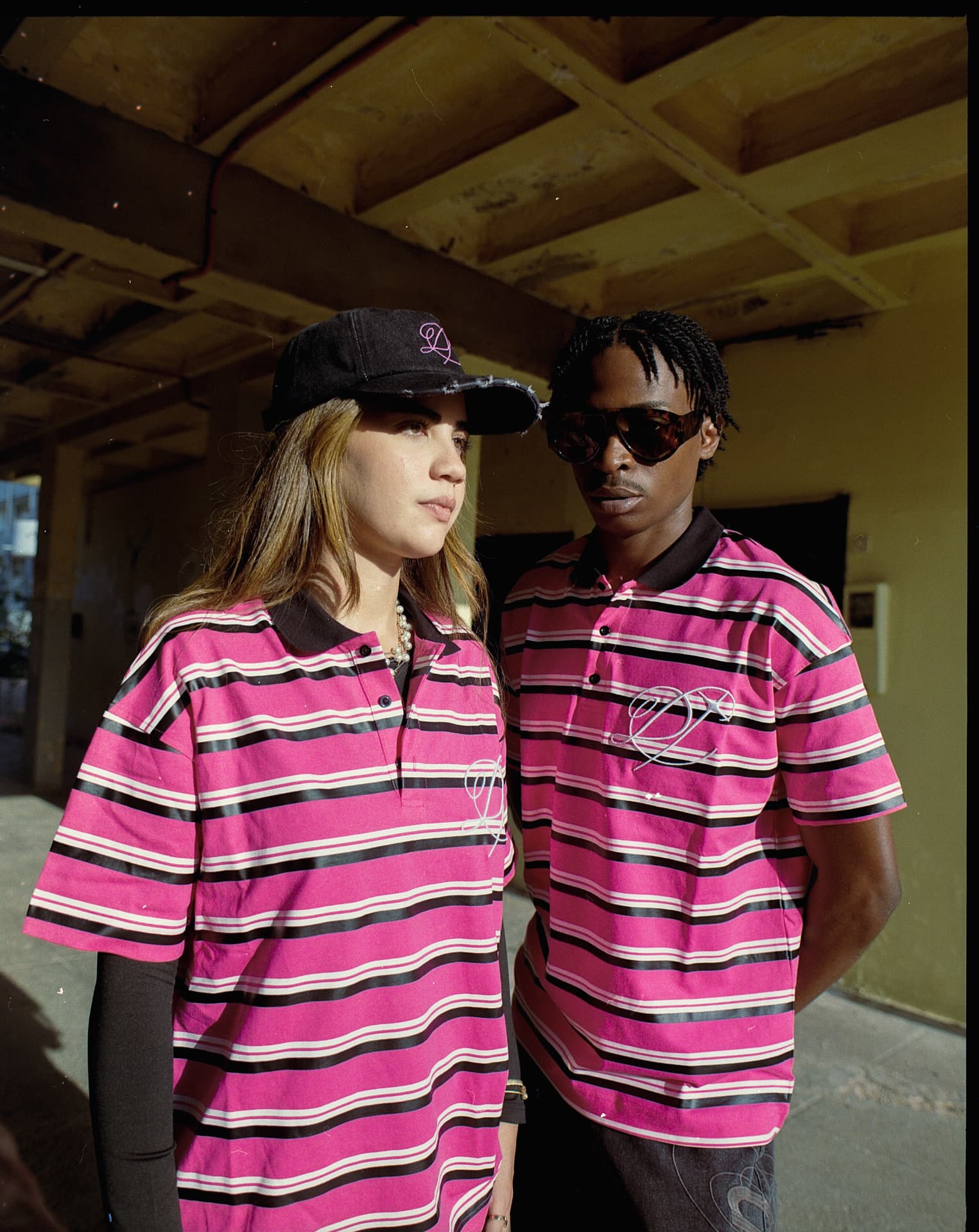 Close-up of DROP striped polos and the monogram cap