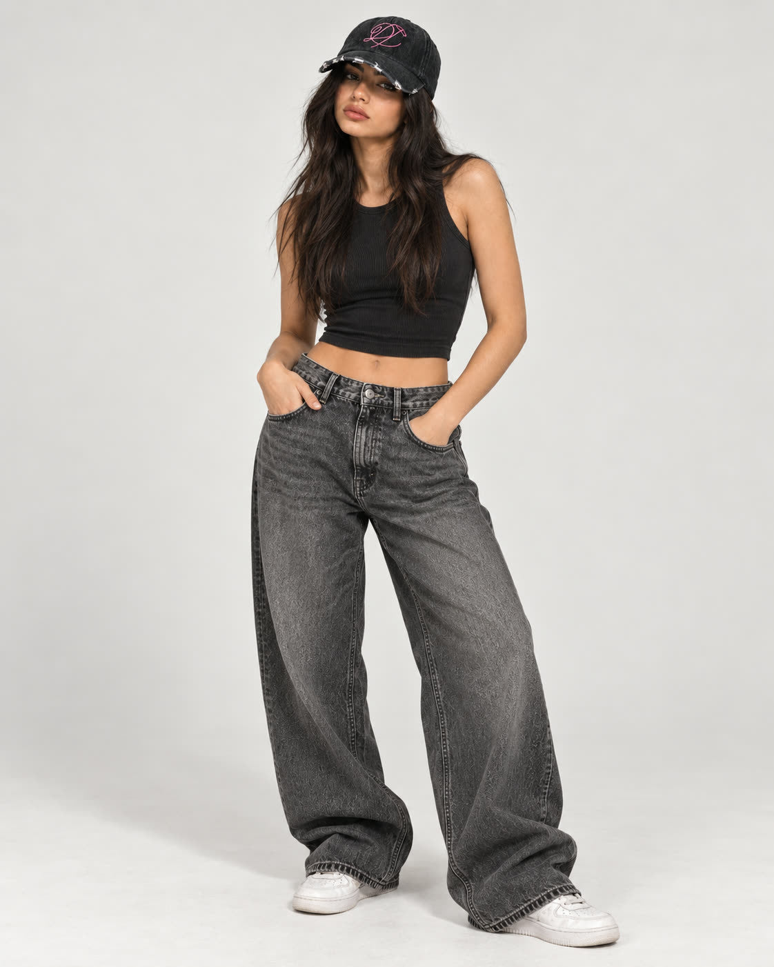 Full-length look of the Scarred Denim Hat styled with washed denim and a black tank top