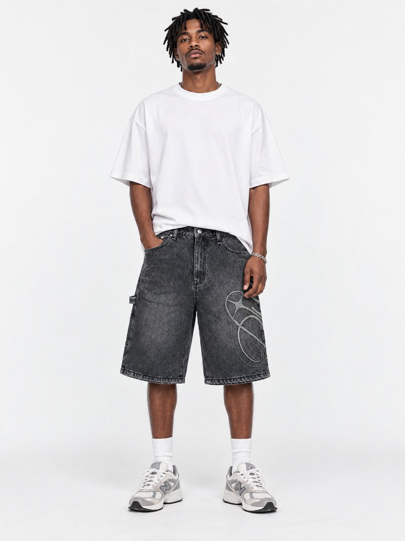 Exhibit 001 Jorts — front view on model, washed black denim with oversized script graphic