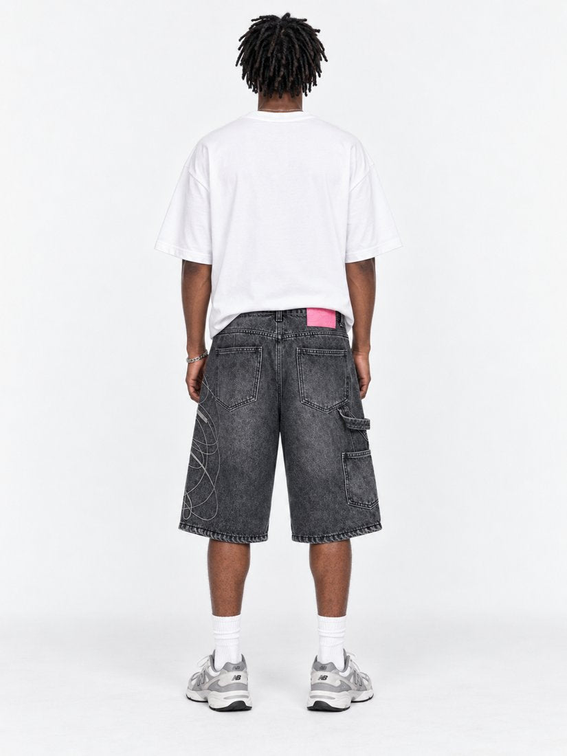Exhibit 001 Jorts — back view on model showing pockets and pink label