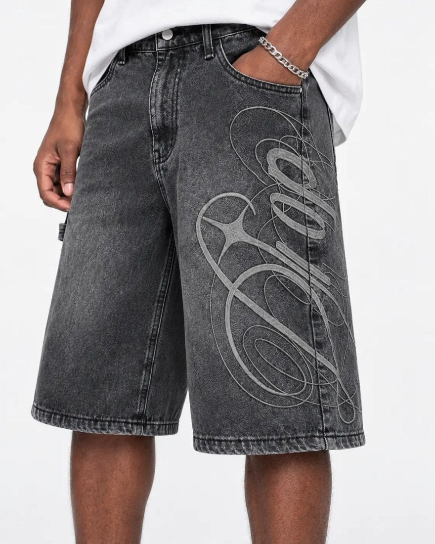 Exhibit 001 Jorts — close-up of washed denim and script graphic