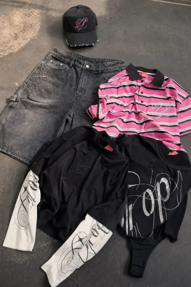 The Heritage collection laid out: striped polo, acid-wash shorts, graphic tee and cap