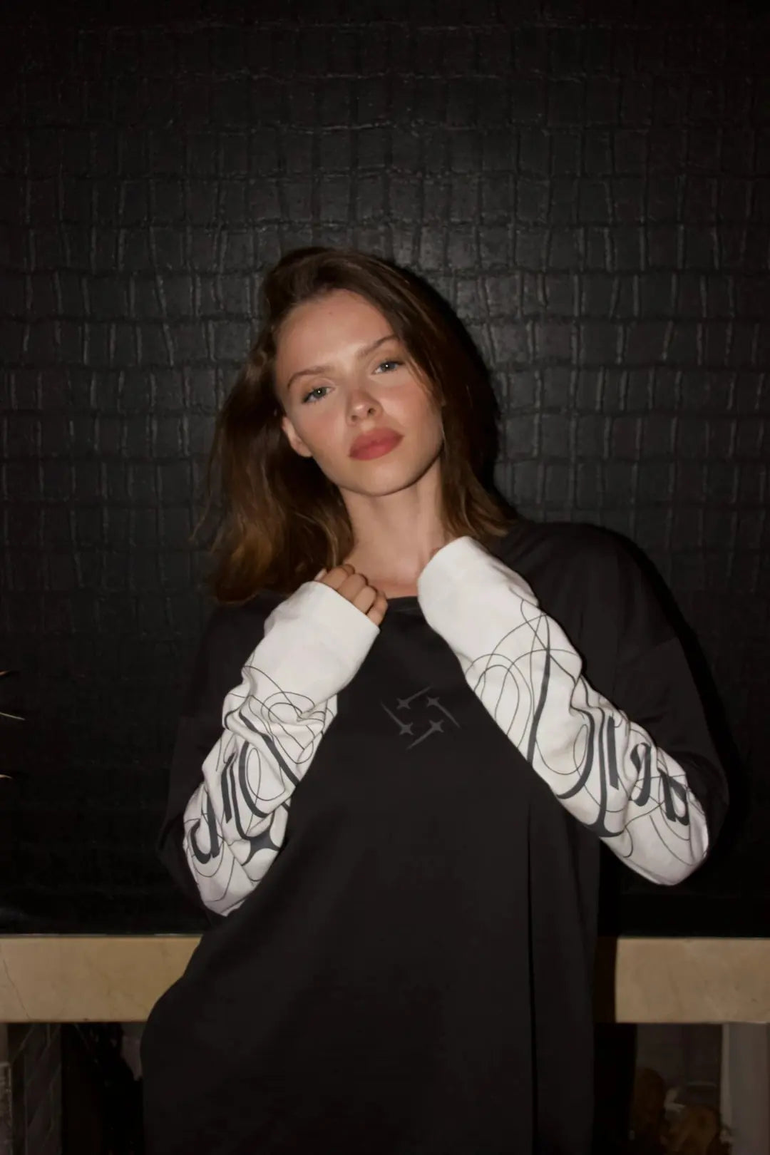 Model wearing the black and white DROP long sleeve at night